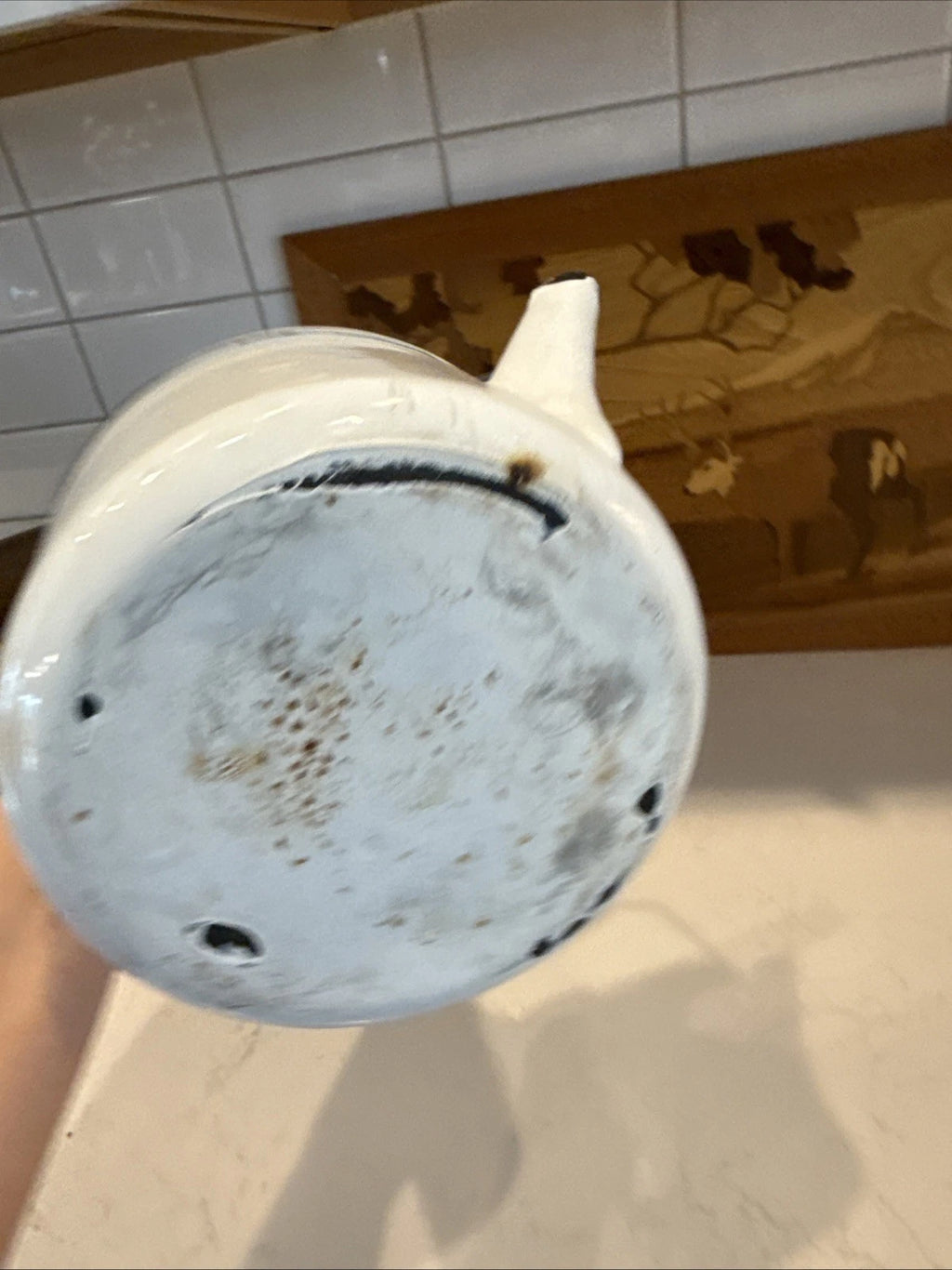 vintage enamel tea kettle with a wood handle, dating from the mid-20th century.