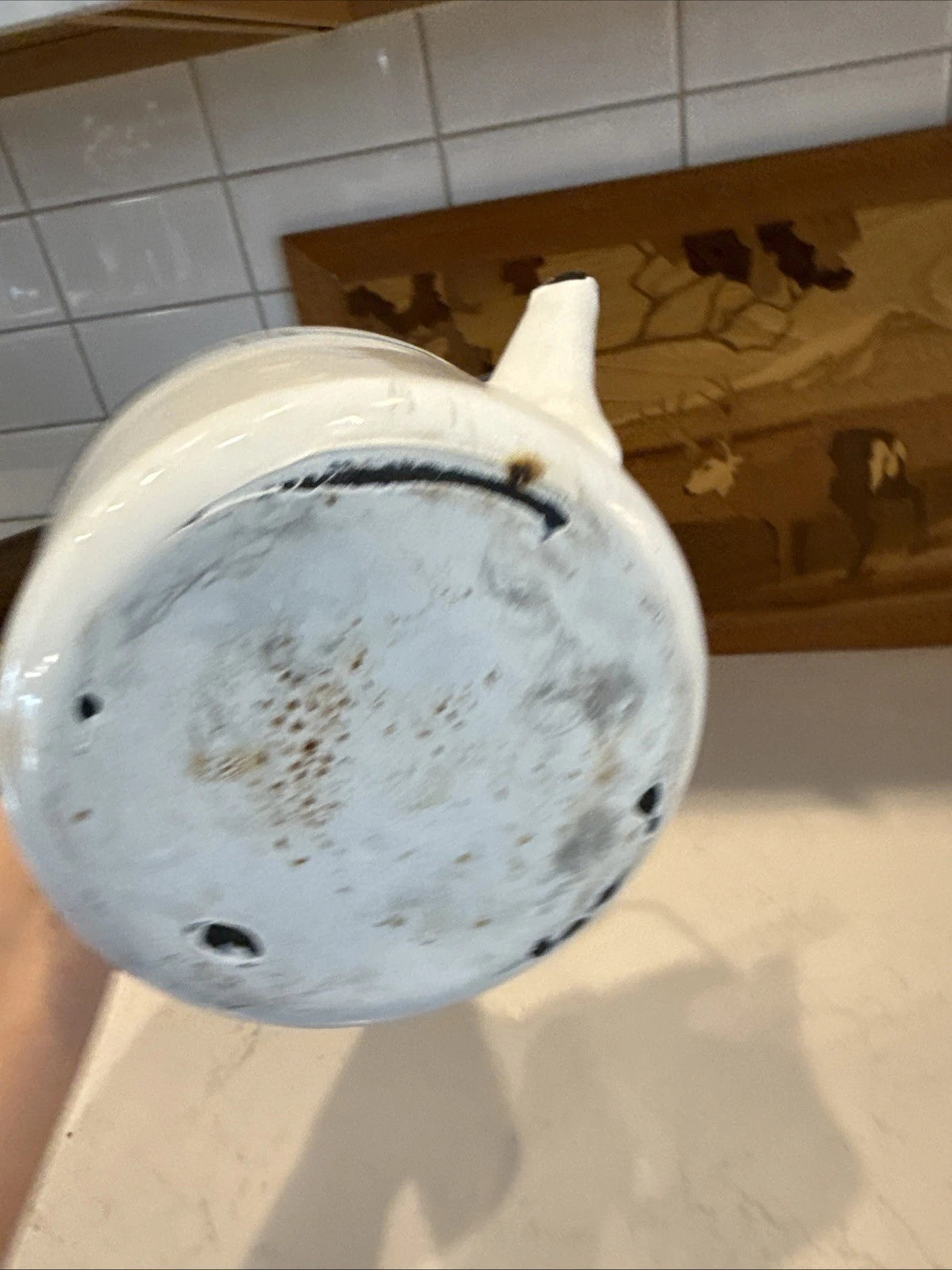 vintage enamel tea kettle with a wood handle, dating from the mid-20th century.