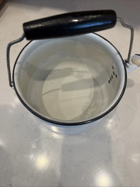 vintage enamel tea kettle with a wood handle, dating from the mid-20th century.