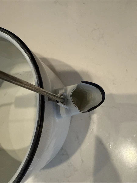 vintage enamel tea kettle with a wood handle, dating from the mid-20th century.